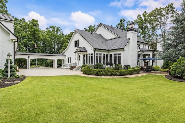 15595 Birmingham Hwy, Alpharetta, GA 30004 - back of house with a chimney, a lawn, and driveway