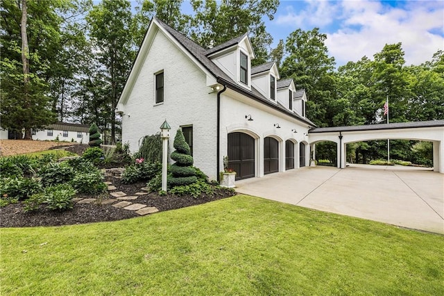 15595 Birmingham Hwy, Alpharetta, GA 30004 - view of side of home featuring a garage, a lawn, and concrete driveway