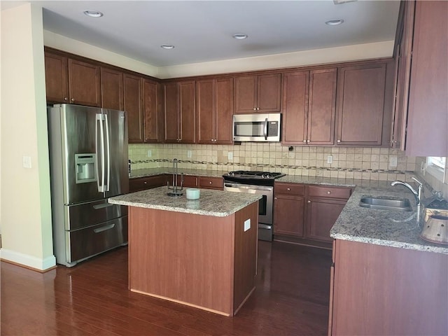 1080 Colgan Ct, Alpharetta, GA 30004 - kitchen with stainless steel appliances, light stone countertops, dark wood finished floors, a kitchen island, and recessed lighting