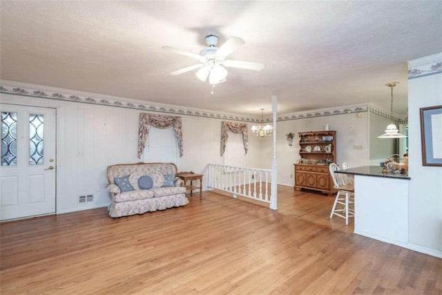1526 N Cherokee Rd N, Social Circle, GA 30025 - living area with ceiling fan, wood finished floors, ornamental molding, an upstairs landing, and a textured ceiling