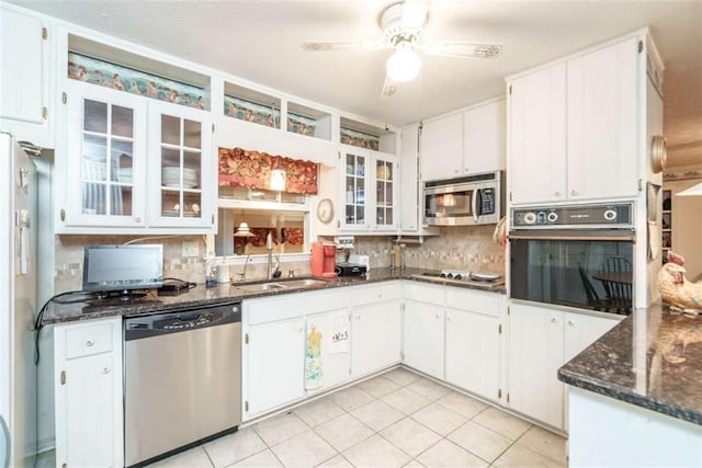 1526 N Cherokee Rd N, Social Circle, GA 30025 - kitchen featuring appliances with stainless steel finishes, a sink, ceiling fan, tasteful backsplash, and dark stone counters
