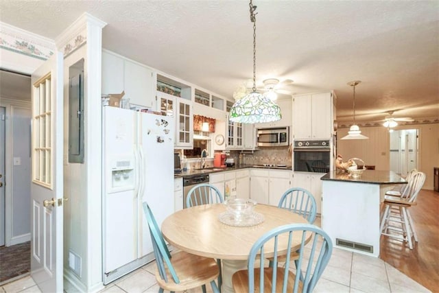 1526 N Cherokee Rd N, Social Circle, GA 30025 - kitchen featuring black appliances, dark countertops, ceiling fan, tasteful backsplash, and a sink