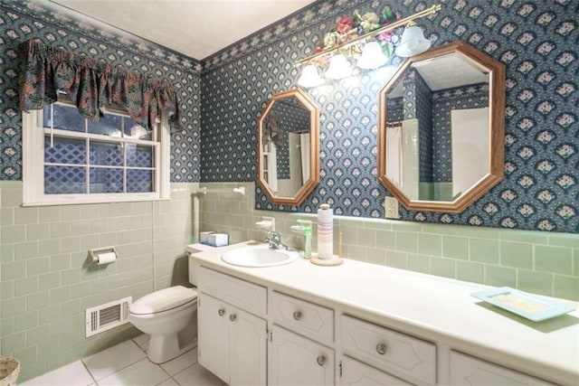 1526 N Cherokee Rd N, Social Circle, GA 30025 - bathroom featuring wallpapered walls, wainscoting, tile walls, toilet, and vanity