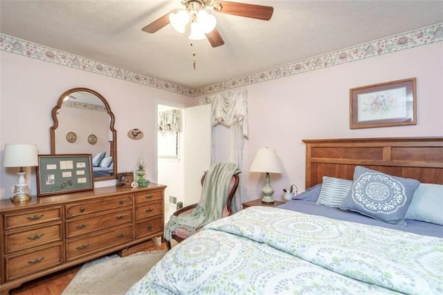 1526 N Cherokee Rd N, Social Circle, GA 30025 - bedroom featuring a ceiling fan, wood finished floors, and a textured ceiling