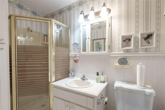 1526 N Cherokee Rd N, Social Circle, GA 30025 - bathroom featuring wallpapered walls, a stall shower, vanity, toilet, and a wainscoted wall