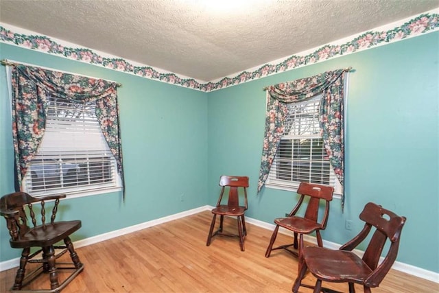 1526 N Cherokee Rd N, Social Circle, GA 30025 - living area featuring a textured ceiling, wood finished floors, and baseboards