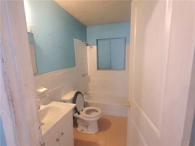 full bathroom with tile walls, tile patterned flooring, vanity, a textured ceiling, and toilet