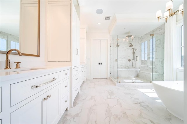bathroom featuring a marble finish shower, vanity, marble finish flooring, a soaking tub, and a chandelier