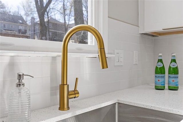 2453 Paul Ave NW, Atlanta, GA 30318 - kitchen view of decorative backsplash, light stone counters, and white cabinets