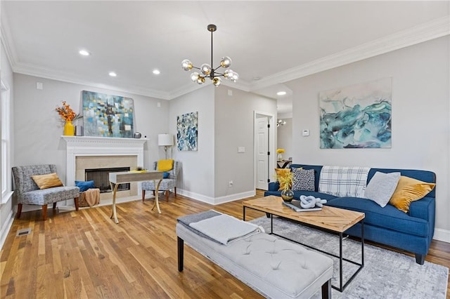 2453 Paul Ave NW, Atlanta, GA 30318 - living area featuring light wood-type flooring, crown molding, recessed lighting, a chandelier, and a fireplace