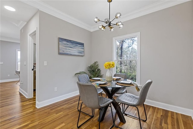 2453 Paul Ave NW, Atlanta, GA 30318 - dining space featuring healthy amount of natural light, crown molding, wood finished floors, and a chandelier