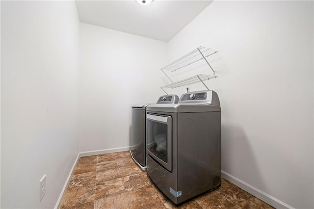 1560 Avalon Creek Rd, Sugar Hill, GA 30518 - washroom featuring washing machine and clothes dryer and stone finish floors