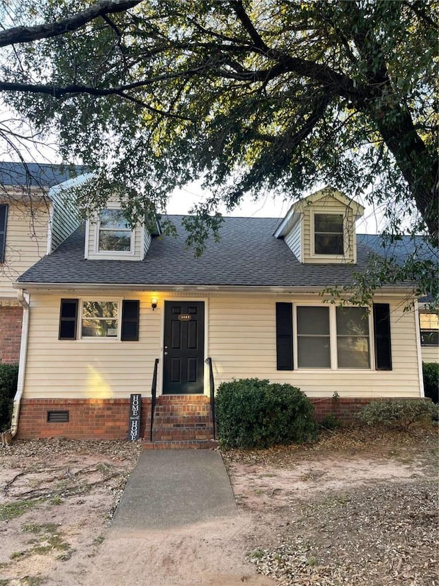 view of front of house with crawl space, a shingled roof, and entry steps