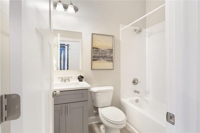 bathroom featuring  shower combination, vanity, toilet, and baseboards