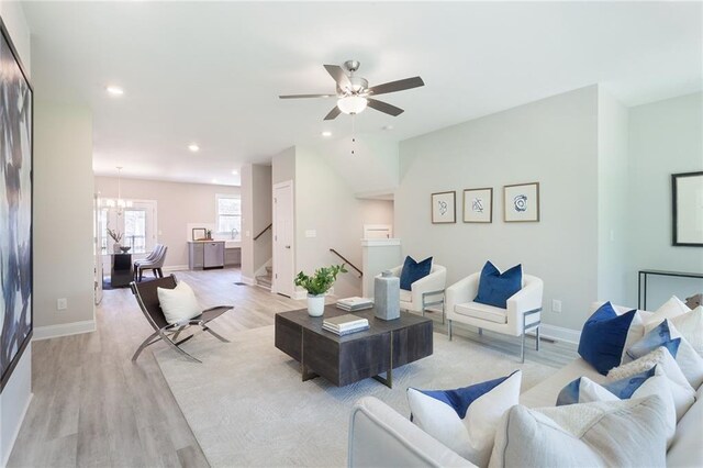 living area with light wood-style flooring, ceiling fan, and recessed lighting