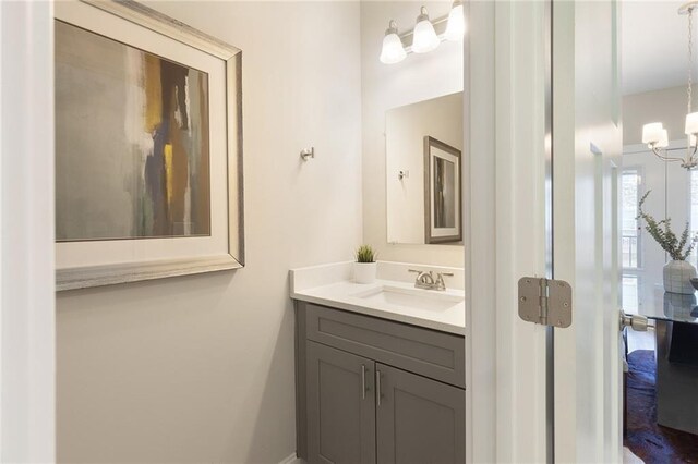 bathroom featuring a chandelier and vanity