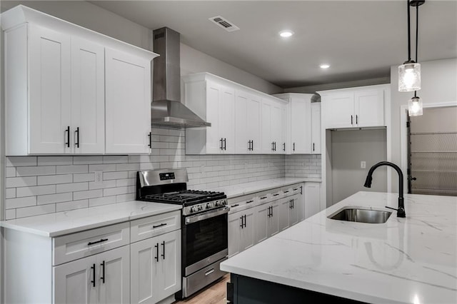 8971 Callaway Dr, Winston, GA 30187 - kitchen featuring light stone countertops, wall chimney exhaust hood, white cabinetry, a sink, and gas stove