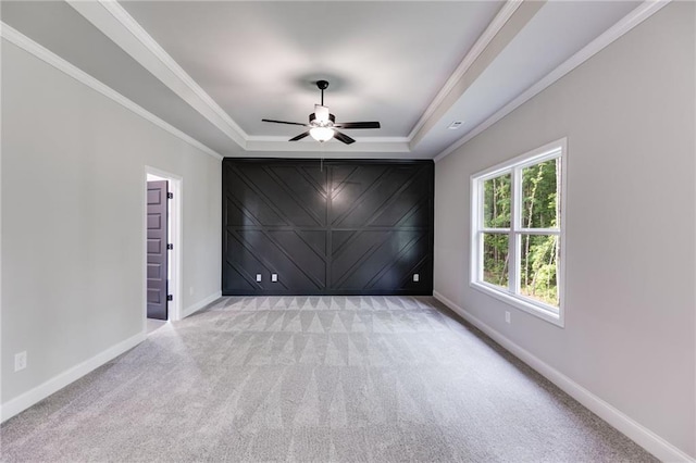 8971 Callaway Dr, Winston, GA 30187 - carpeted spare room with a ceiling fan, baseboards, an accent wall, ornamental molding, and a tray ceiling