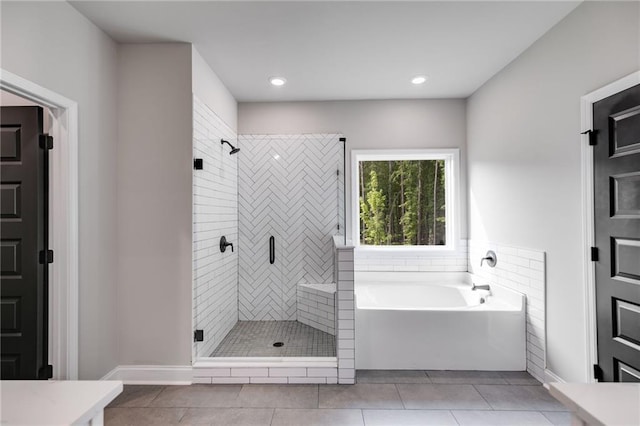 8971 Callaway Dr, Winston, GA 30187 - full bath featuring tile patterned floors, a shower stall, and a garden tub