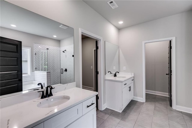 8971 Callaway Dr, Winston, GA 30187 - bathroom featuring visible vents, a sink, a stall shower, and two vanities