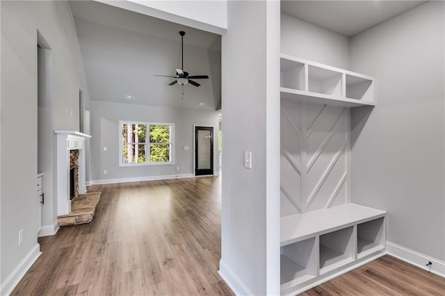 8971 Callaway Dr, Winston, GA 30187 - mudroom featuring a ceiling fan, a fireplace, wood finished floors, baseboards, and high vaulted ceiling