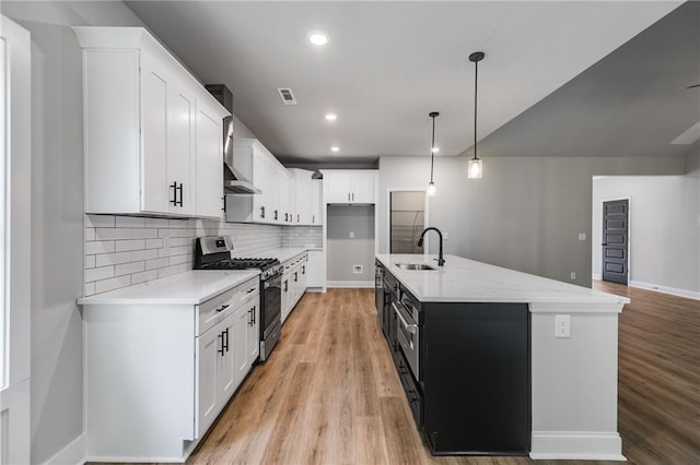 8971 Callaway Dr, Winston, GA 30187 - kitchen featuring a sink, light wood finished floors, stainless steel gas stove, and decorative backsplash