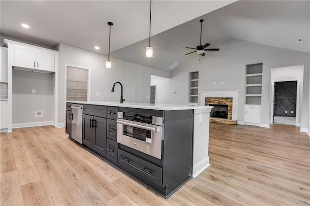 8971 Callaway Dr, Winston, GA 30187 - kitchen featuring a ceiling fan, appliances with stainless steel finishes, built in shelves, light countertops, and white cabinets