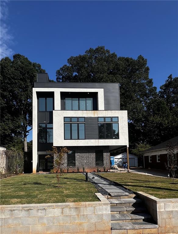 modern home featuring a front yard