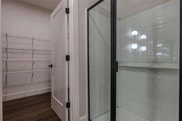 bathroom featuring hardwood / wood-style floors, vanity, and walk in shower