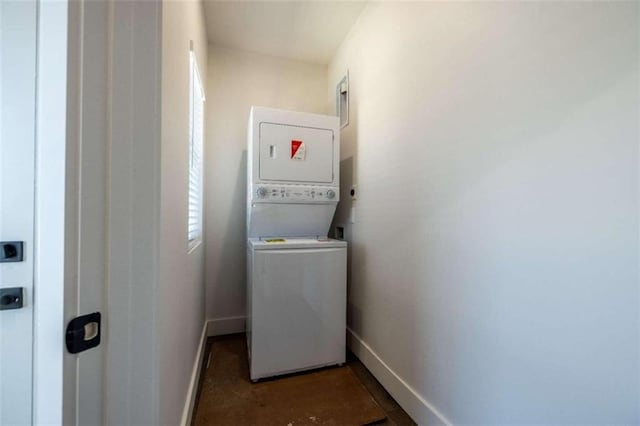 clothes washing area featuring stacked washer / drying machine