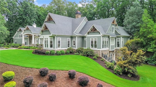 rear view of property featuring a yard