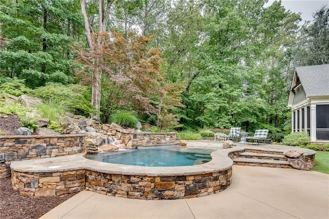 view of swimming pool featuring a patio area