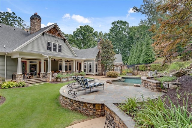 back of house featuring a yard and a patio area