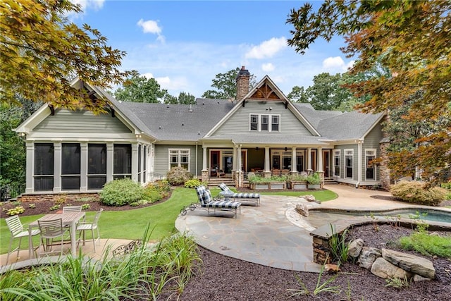 back of property featuring a yard and a patio