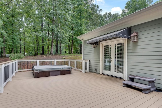 deck featuring a covered hot tub and french doors