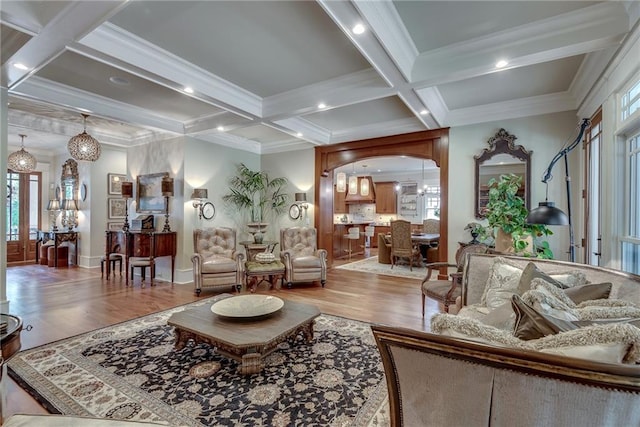 living room featuring coffered ceiling, beamed ceiling, hardwood / wood-style flooring, and ornamental molding