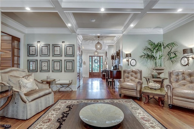 living room featuring coffered ceiling, hardwood / wood-style flooring, and crown molding