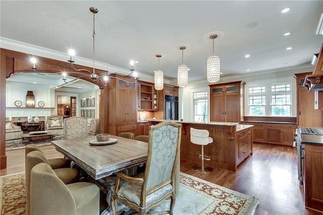 dining space featuring ornamental molding and hardwood / wood-style floors