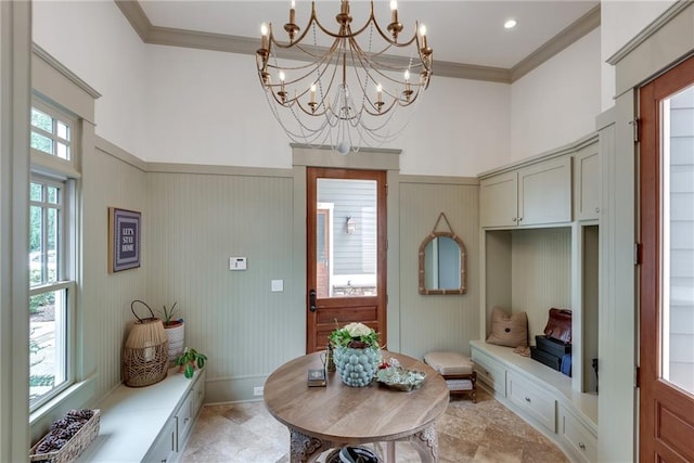 interior space with ornamental molding and a chandelier