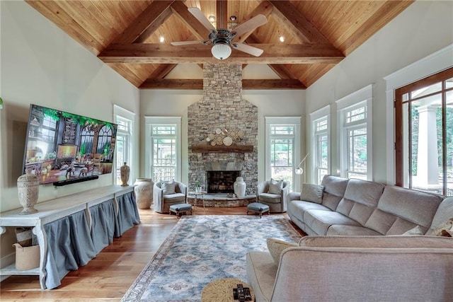 living room with wood ceiling, ceiling fan, and a wealth of natural light