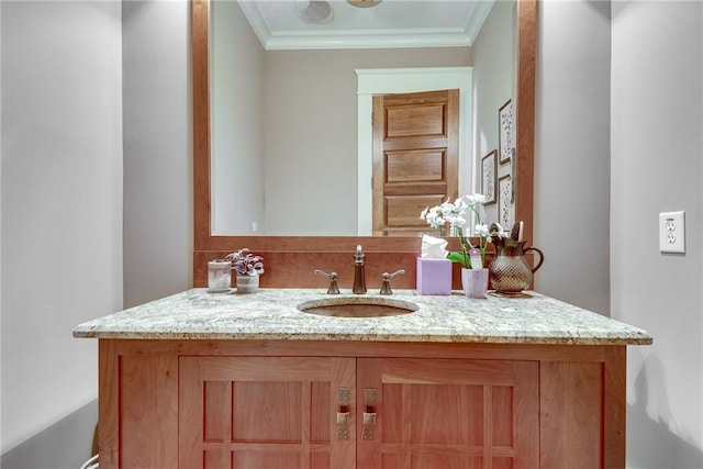 bathroom with crown molding and vanity