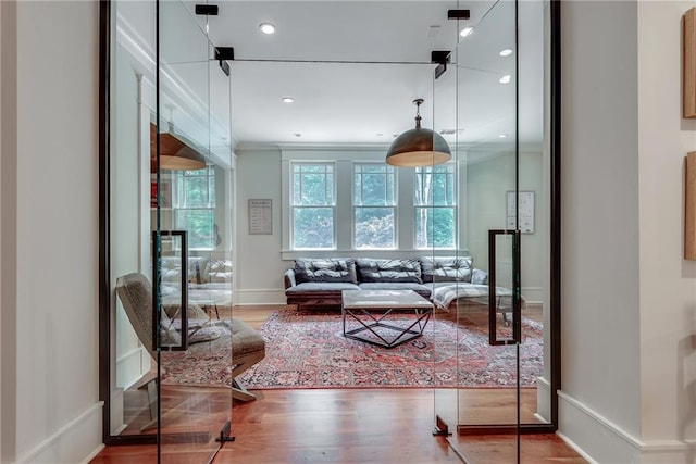 living room with ornamental molding and hardwood / wood-style floors