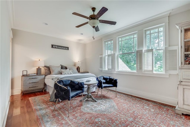 bedroom featuring wood-type flooring, ceiling fan, multiple windows, and crown molding