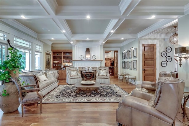 living room featuring ornamental molding, beamed ceiling, coffered ceiling, and light hardwood / wood-style flooring