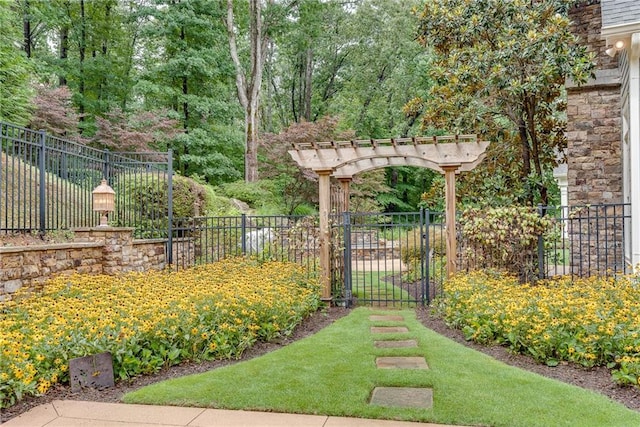 view of gate featuring a lawn and a pergola