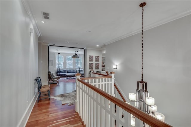 hall featuring crown molding and light hardwood / wood-style floors