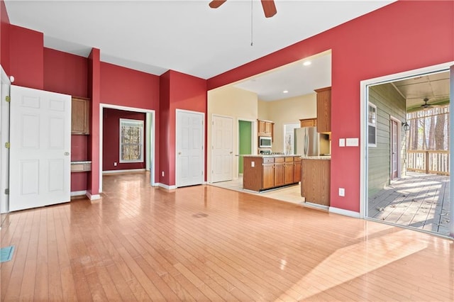 unfurnished living room featuring light hardwood / wood-style floors and ceiling fan