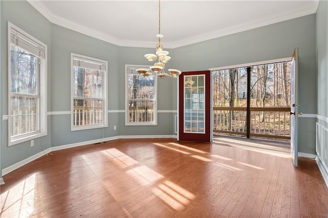 interior space featuring a chandelier, wood-type flooring, and ornamental molding