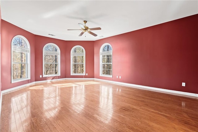 spare room featuring hardwood / wood-style floors and ceiling fan