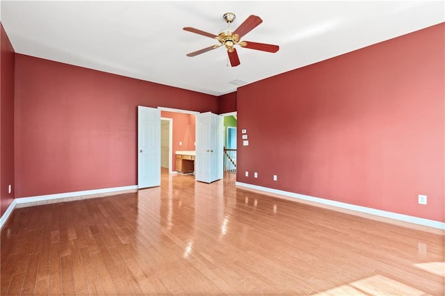 empty room with ceiling fan and hardwood / wood-style flooring